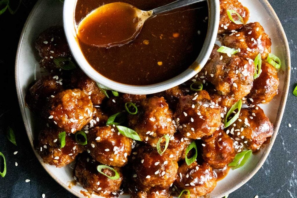 Asian inspired meatballs with sauce.