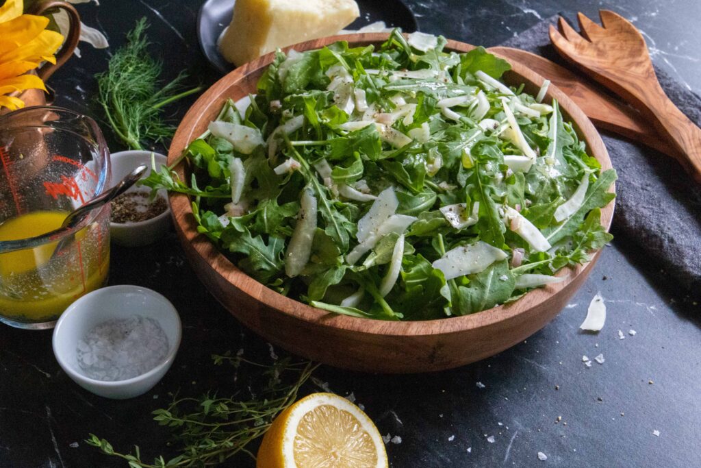 arugula fennel salad in wooden bowl