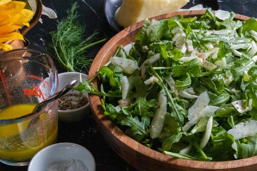 arugula fennel salad in a wooden bowl