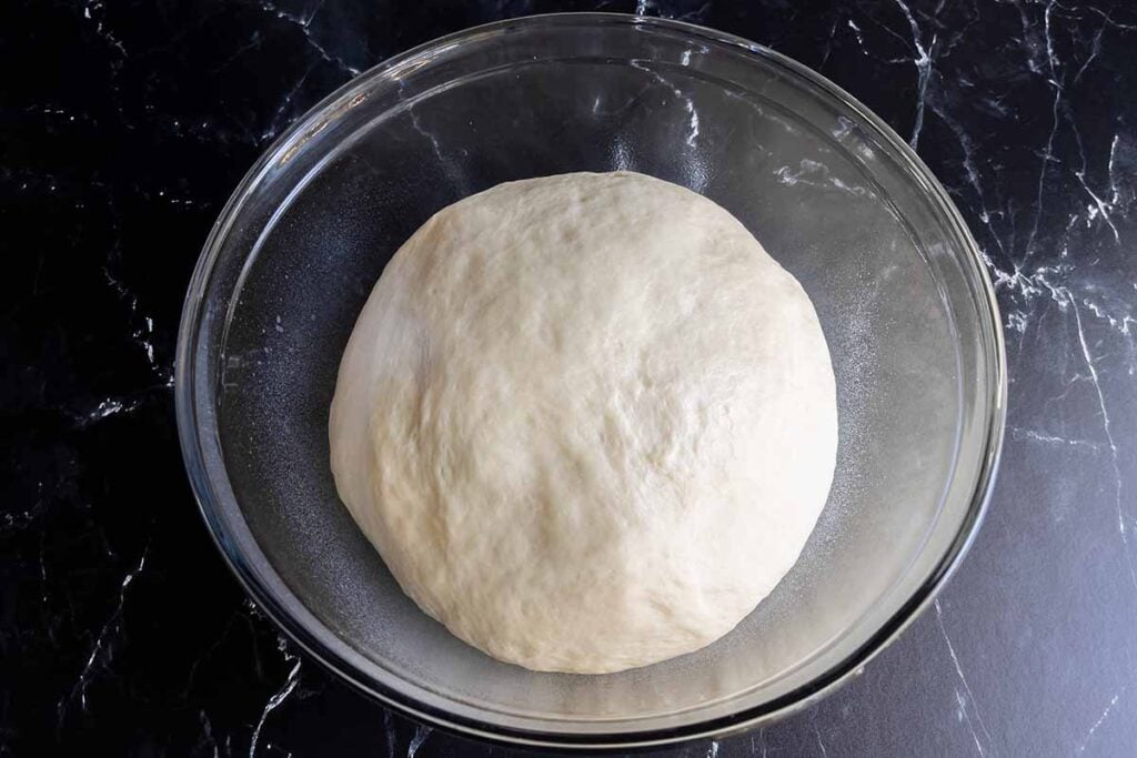 dough that has risen in a glass bowl