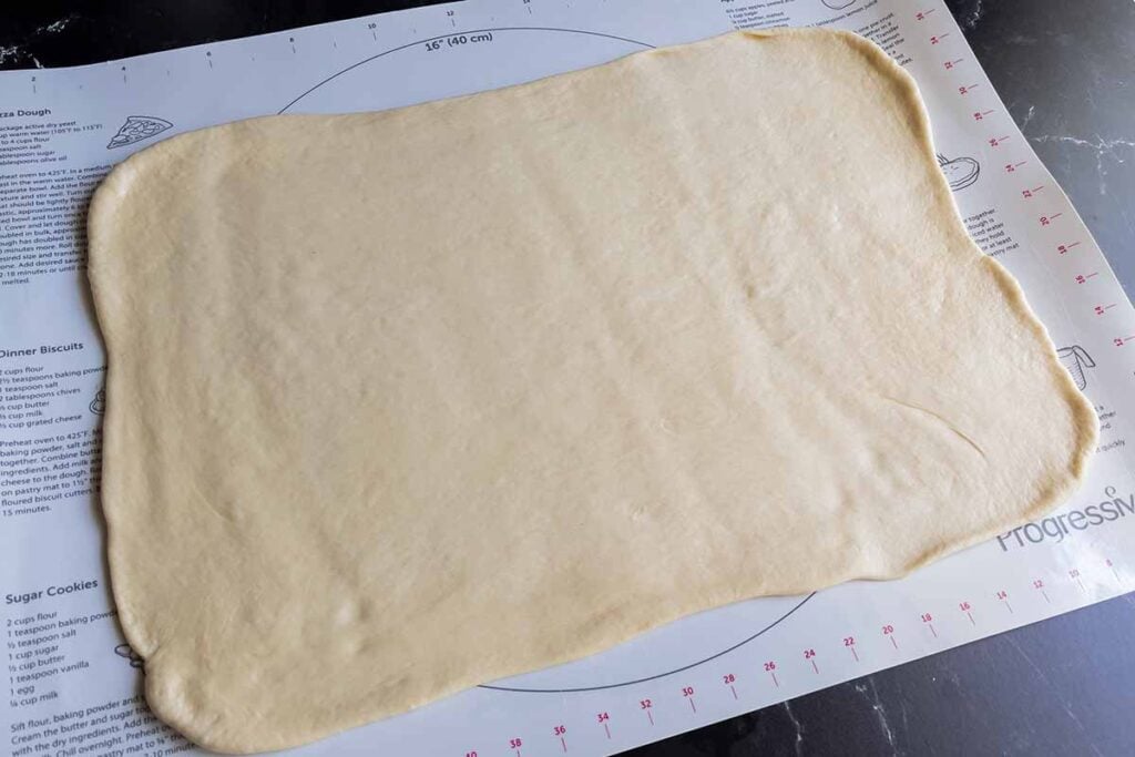 Cinnamon roll dough shaped into a rectangle.