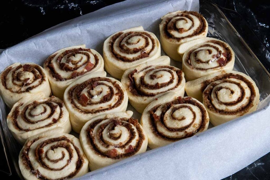 Maple bacon cinnamon rolls proofed and about to go into the oven.