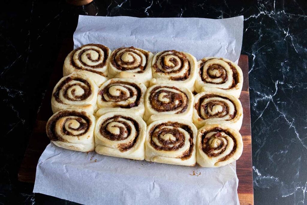 Baked maple bacon cinnamon rolls out of the oven without icing.