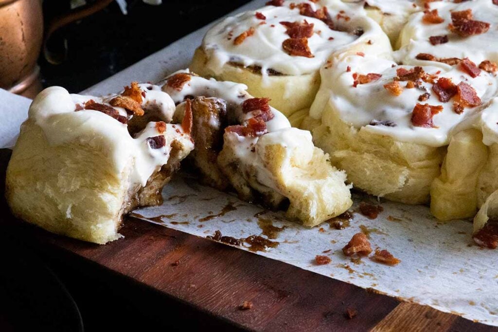 A maple bacon cinnamon roll cut open.