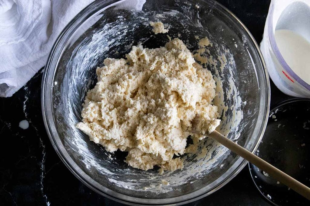 Biscuit dough in glass mixing bowl.