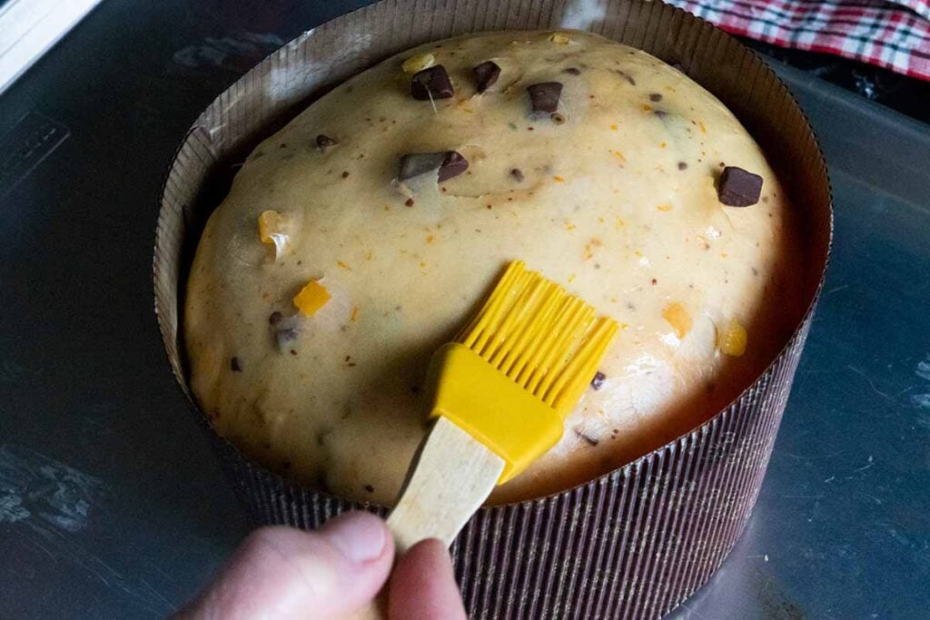 brushing the egg wash on risen dough