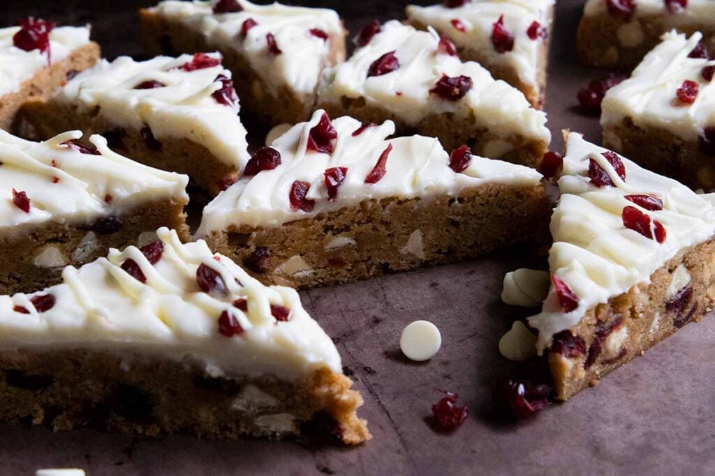 Cranberry bliss bars layed out on a sheet tray.