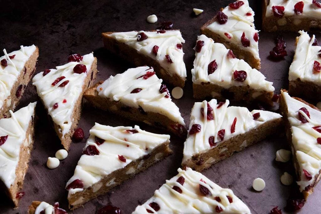 slices of cranberry bliss bars on a sheet pan