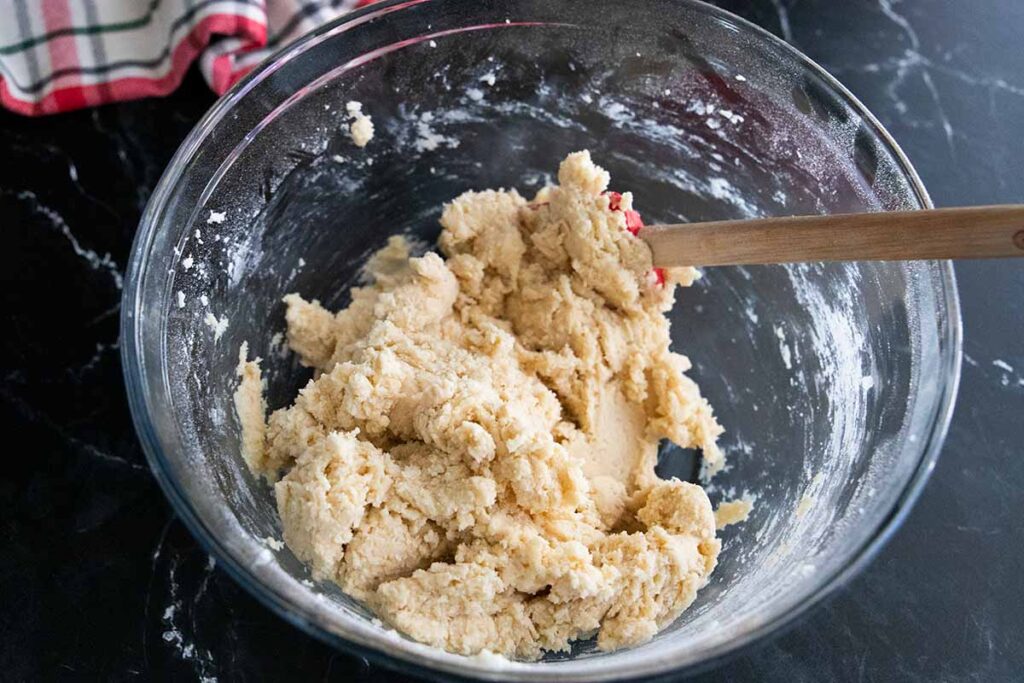 Eggnog cookie dough in a glass mixing bowl.
