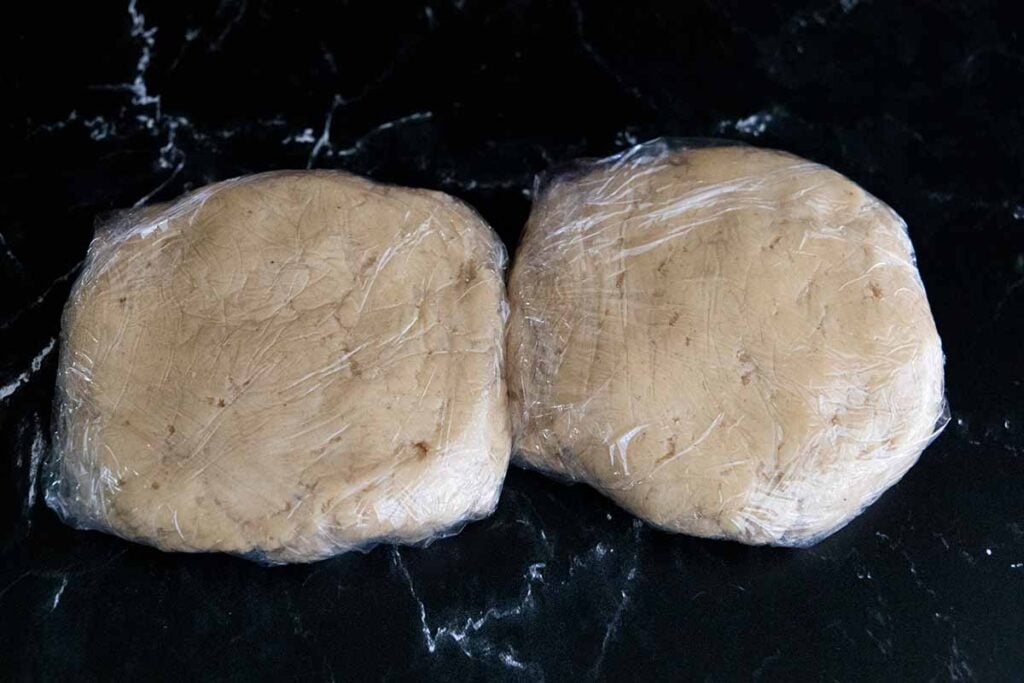 Eggnog cookie dough wrapped in plastic wrap.