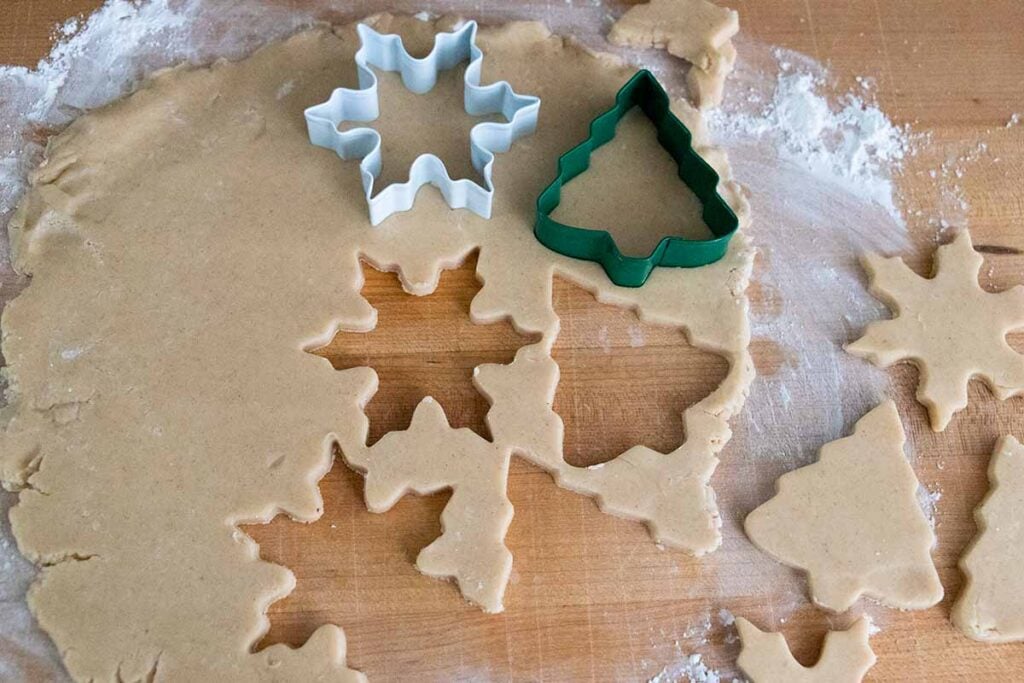 Cookie cutters in the rolled eggnog cookie dough.