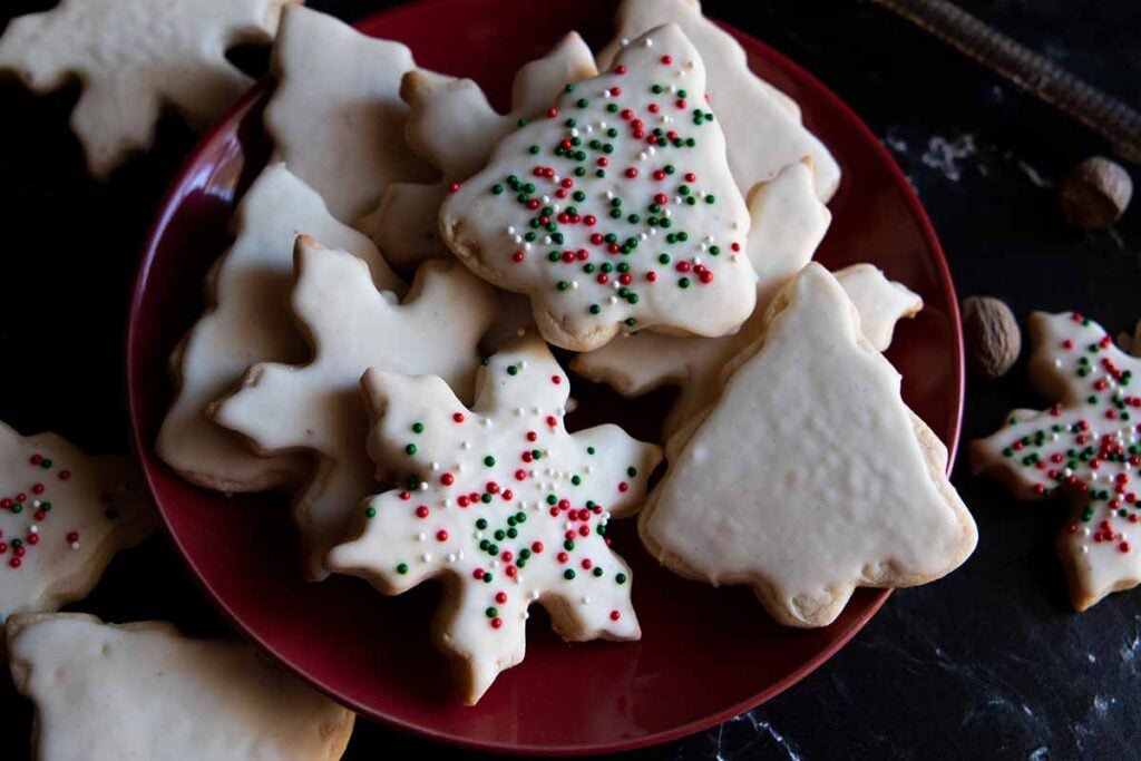 Eggnog cookies stacked on a red plate.