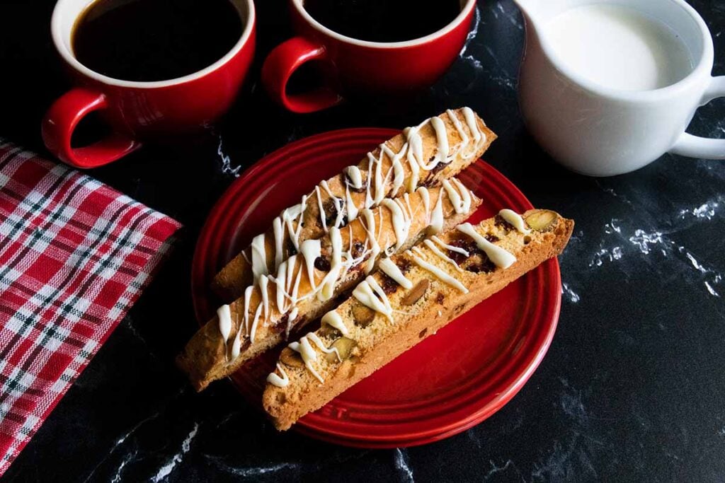 slices of cranberry pistachio biscotti on a red plate