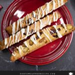 White chocolate cranberry pistachio biscotti on a dark plate.