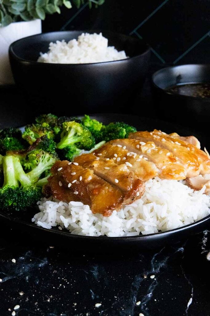 Crispy chicken teriyaki thighs on a bed of rice with broccoli