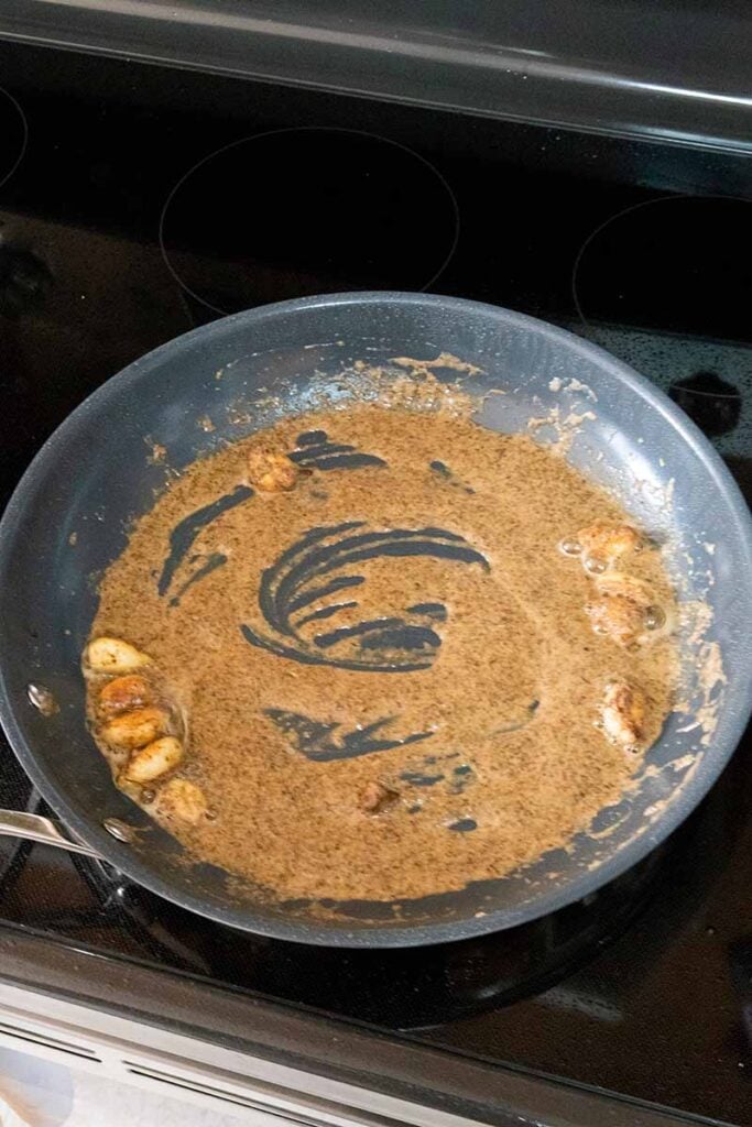 The beginnings of a creamy garlic sauce in a skillet.