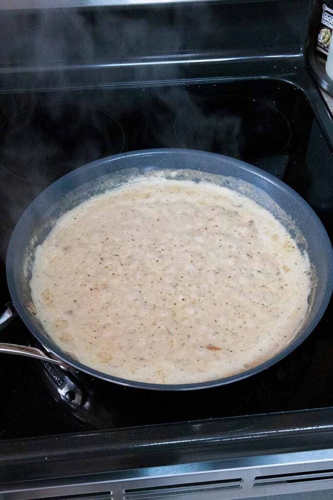 Creamy garlic sauce on a simmer