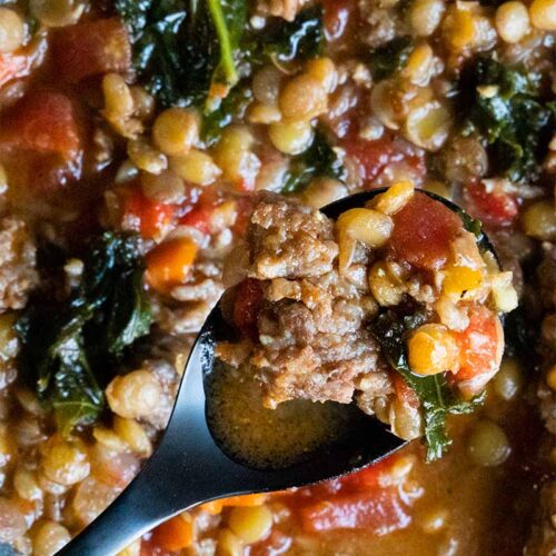 soup on a black spoon over the bowl