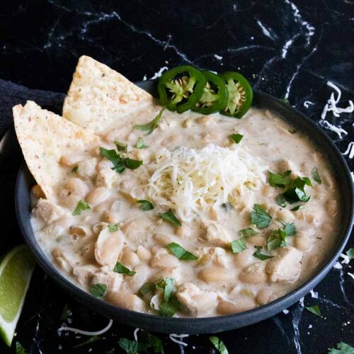 White chicken chili in a black bowl