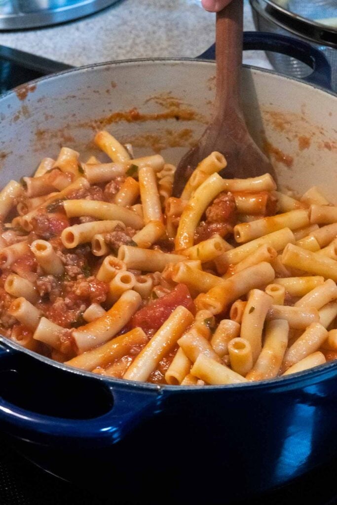 adding ziti noodles to a sauce