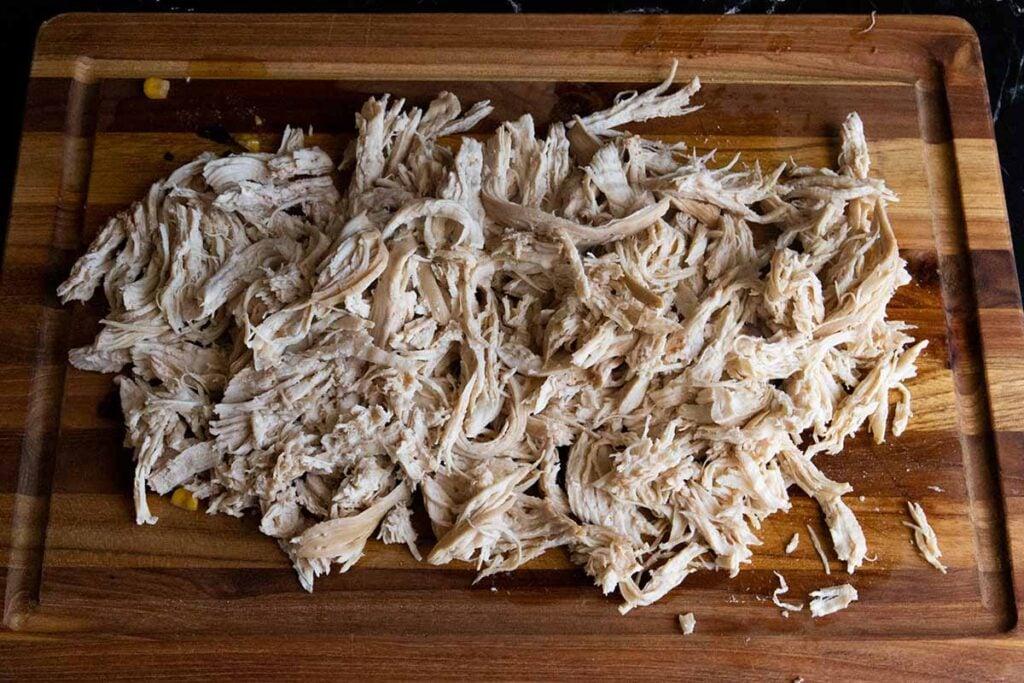 shredded chicken on a cutting board