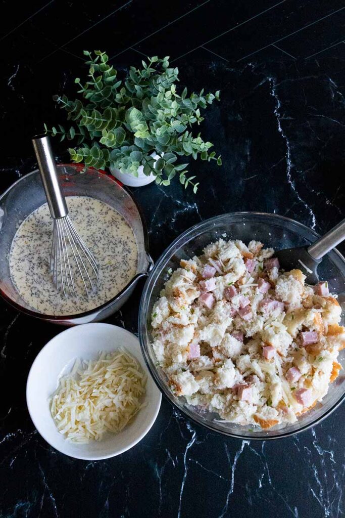 Strata ingredients in two glass mixing bowls