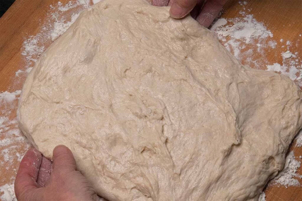 Laying out bread dough into a rectangle.
