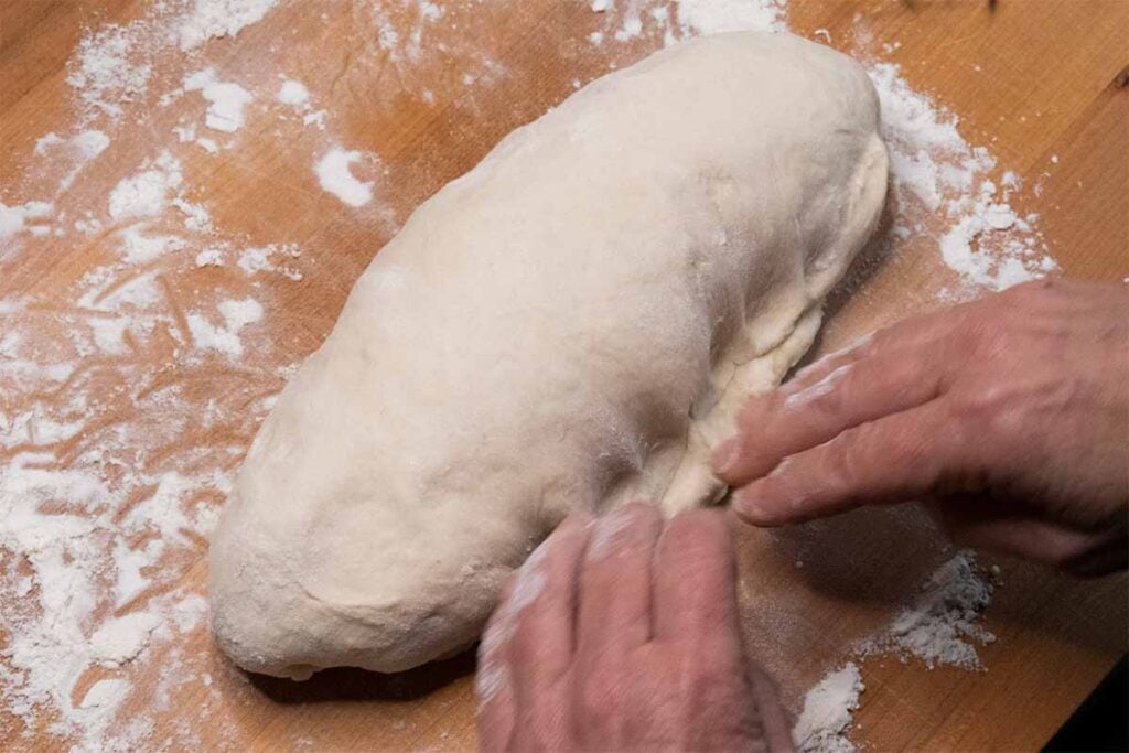 Putting a seam on the bread dough.