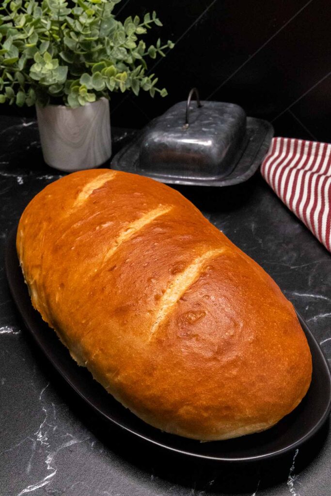 Italian bread loaf on a black platter