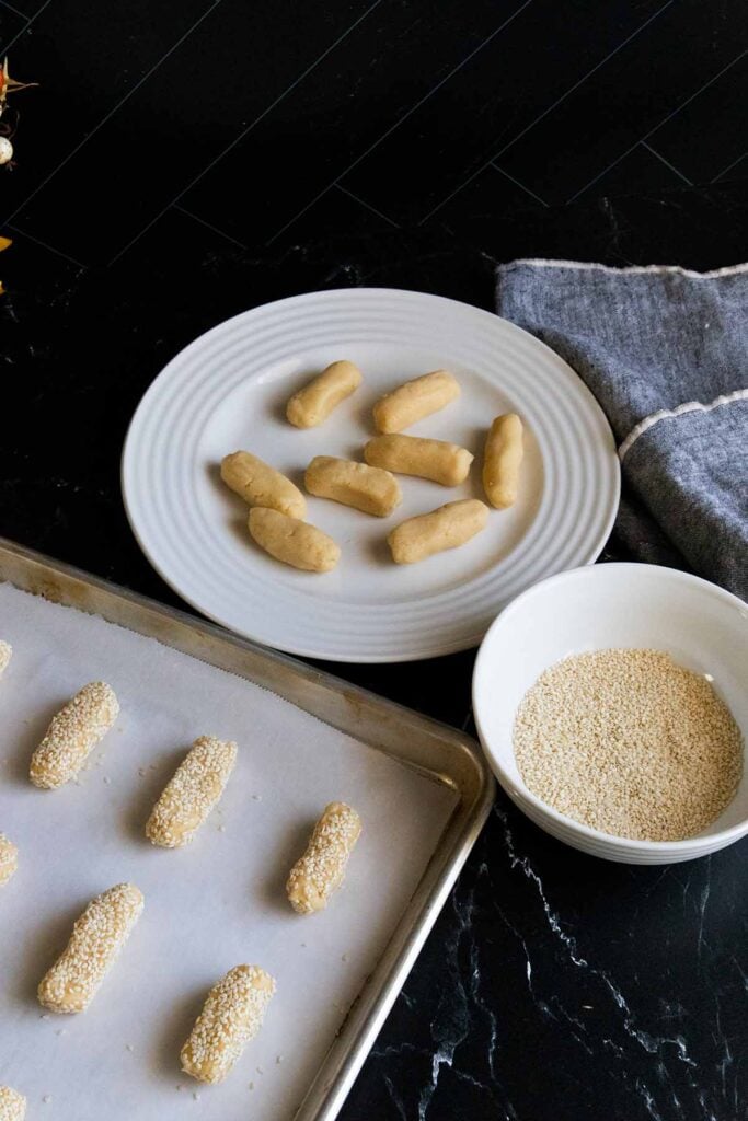 sesame cookie dough logs on parchment paper lined baking sheet