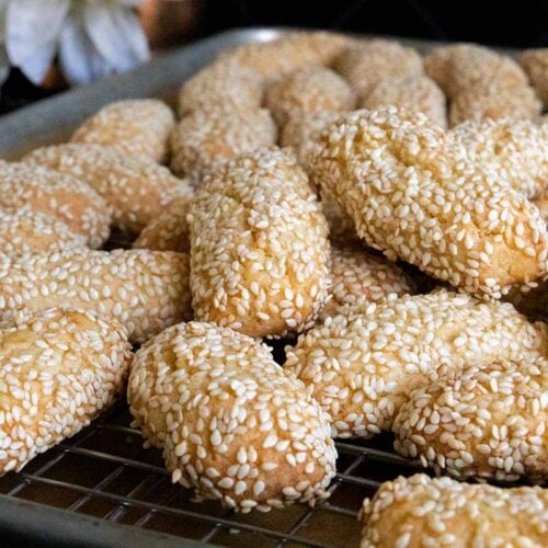 Italian sesame seed cookies on baking sheet.