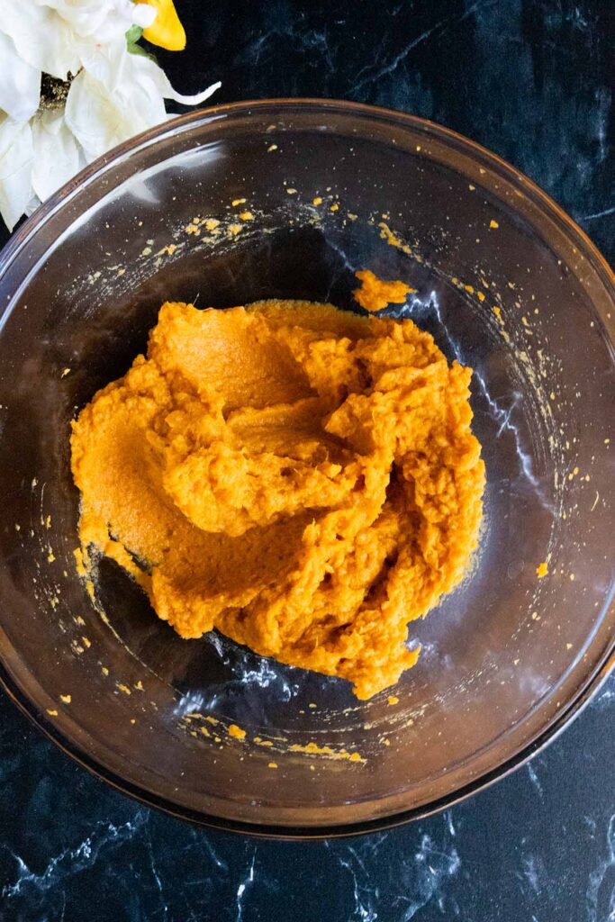 mashed sweet potatoes in a glass mixing bowl