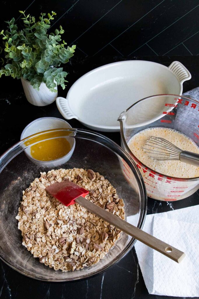 Baked oatmeal ingredients mixed in a large bowl.