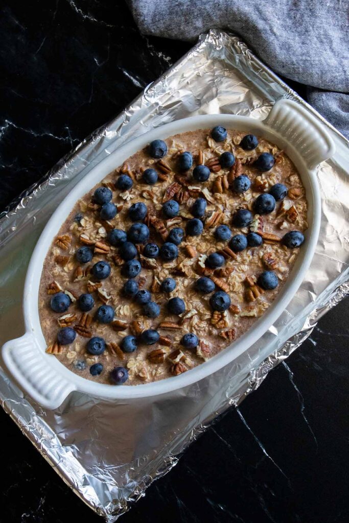Unbaked blueberry oatmeal on a foil lined baking sheet.