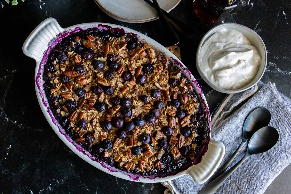 blueberry baked oatmeal in a white oval baking dish