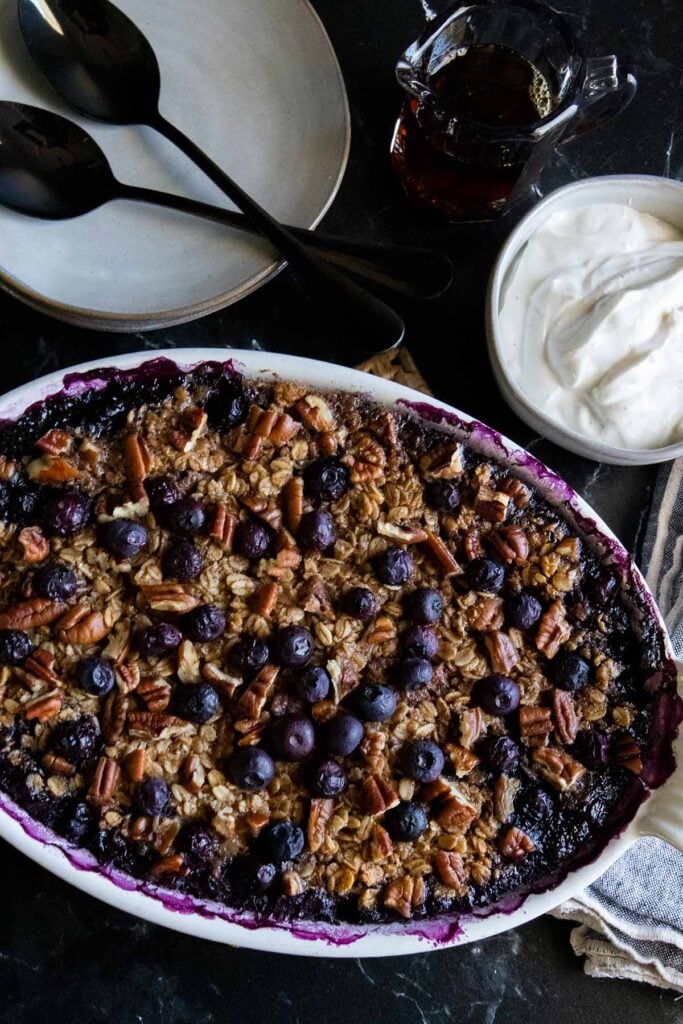 blueberry baked oatmeal in a white oval baking dish