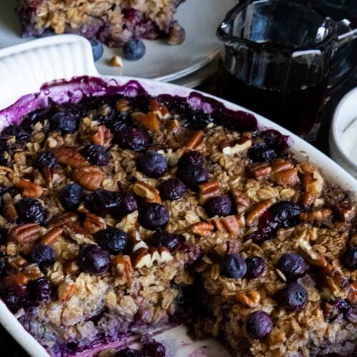 blueberry baked oatmeal in a white oval baking dish