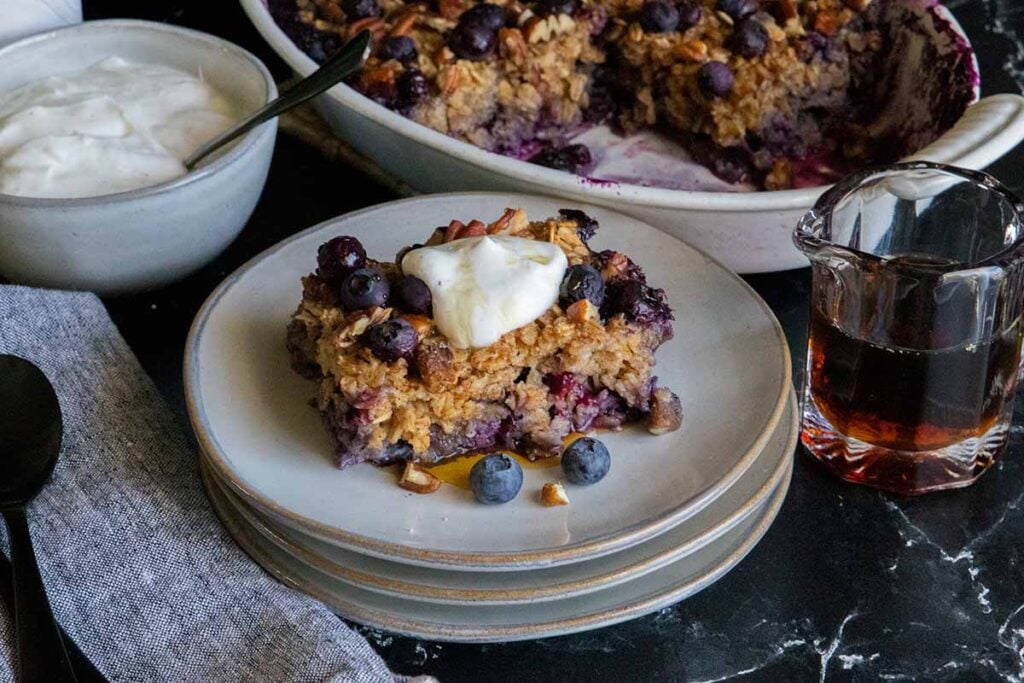 Slice of blueberry baked oatmeal on a gray plate.