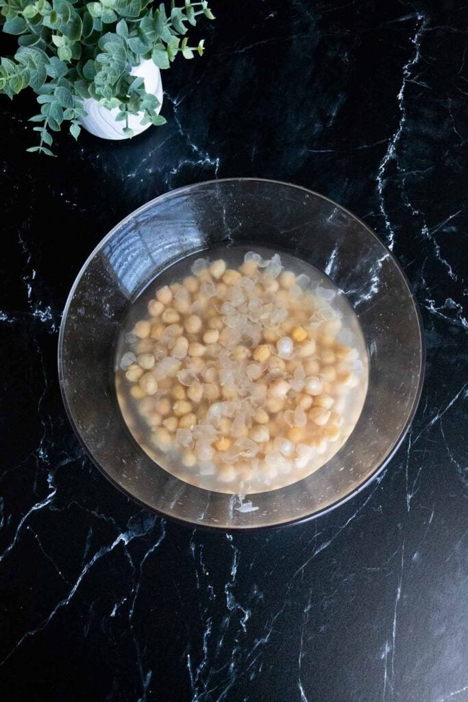 chickpeas in a glass bowl covered with water