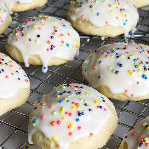 Italian ricotta cookies with glaze drying on a wire rack