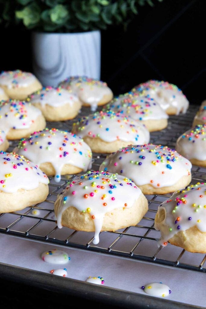 Italian ricotta cookies with glaze drying on a wire rack