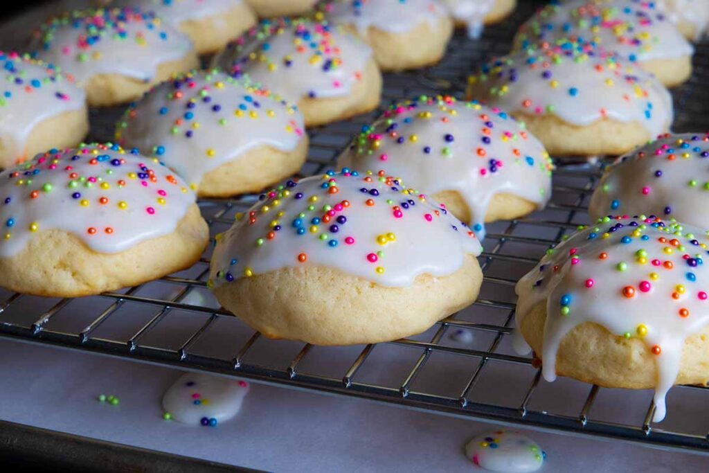 Italian ricotta cookies with glaze drying on a wire rack