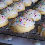 Italian ricotta cookies with glaze drying on a wire rack