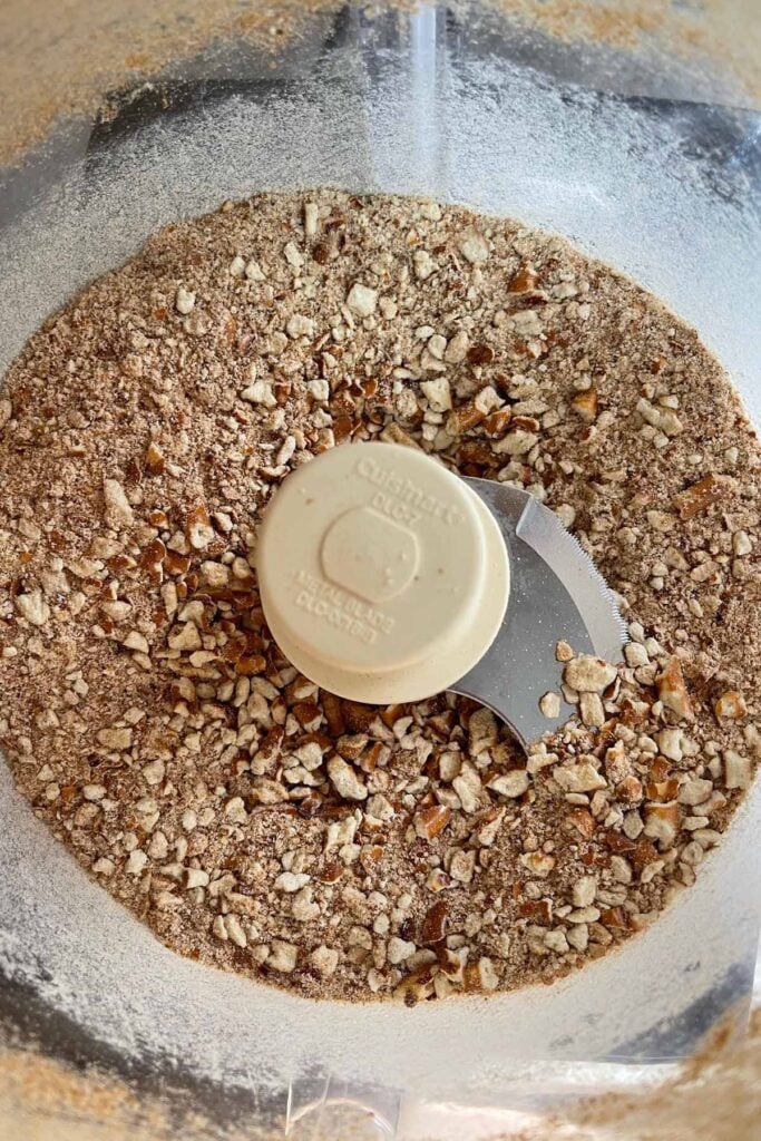 Pretzels crushed in a food processor bowl.