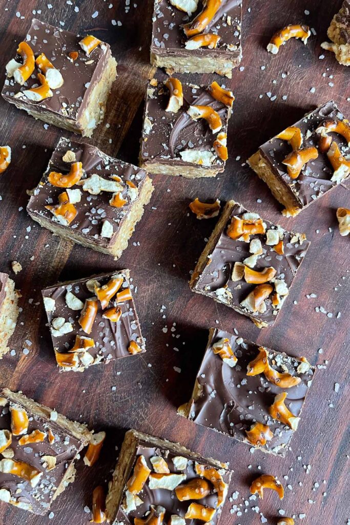 peanut butter pretzel bars on a wooden cutting board