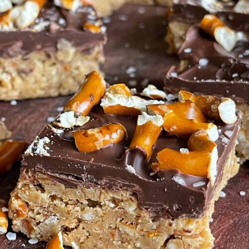 peanut butter pretzel bars on a wooden cutting board