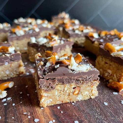 Peanut butter pretzel bars on a dark wooden board.