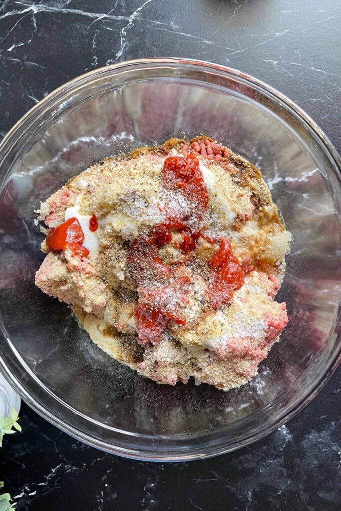 meatloaf ingredients in a bowl waiting to be mixed together.