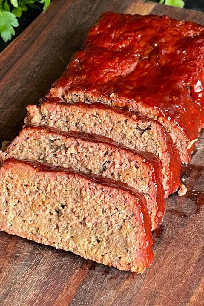 smoked meatloaf on a cutting board sliced.