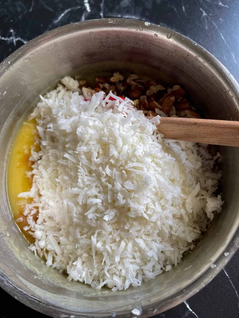 Coconut pecan frosting in a metal mixing bowl.